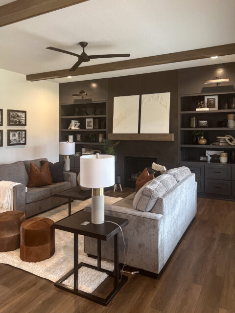 Great room with modern fireplace, built-in shelving, and vaulted ceiling in a custom home by Wannemacher Design Build in Fort Wayne, Indiana.